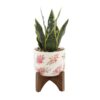 Flora Bunda 12 in. Faux Snake Plant in Flower Print White Ceramic Pot on Wood Stand